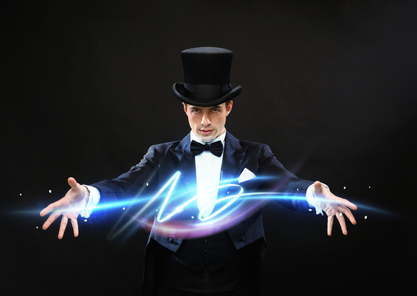 Magician in top hat showing trick - Φωτογραφία, εικόνα