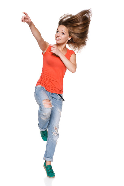 Jumping girl pointing to the side - Foto, imagen