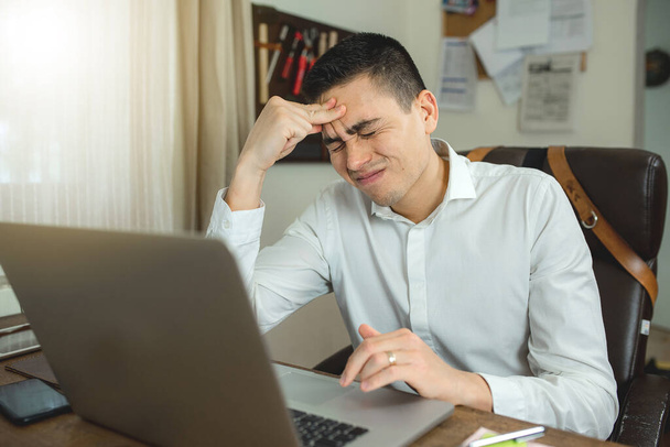 businessman working on laptop having headache. Stress, burnout concept. - Foto, imagen