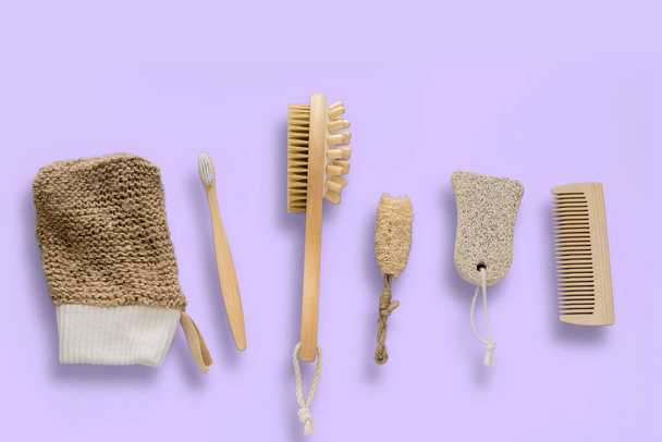 top view flat lay jute washcloth, loofah face sponge, bamboo tooth brush, natural pumice for foot peeling, dry brush massager and hair comb  on a pastel background, eco friendly bathroom set concept - Фото, зображення