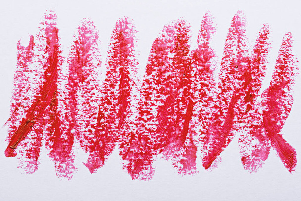 art strokes of scarlet red lipstick on white background, cosmetic smears - Photo, Image