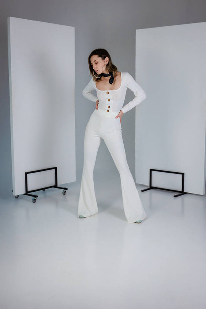 Beautiful young woman dressing white in white studio - Foto, imagen