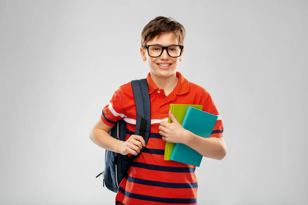 smiling student boy with backpack and books - Φωτογραφία, εικόνα