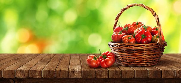 Freshly tomatoes in a basket on a wooden table - Фото, зображення