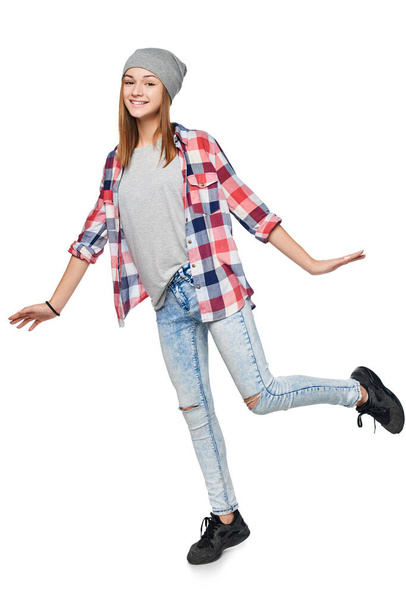 Smiling teen girl standing on one leg - Fotoğraf, Görsel