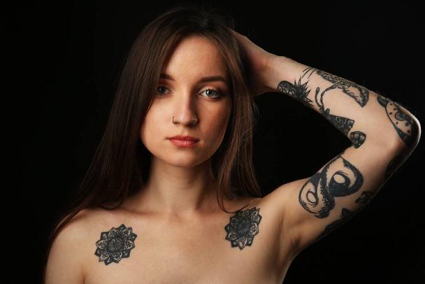 Young woman with tattoo on dark background - Photo, Image