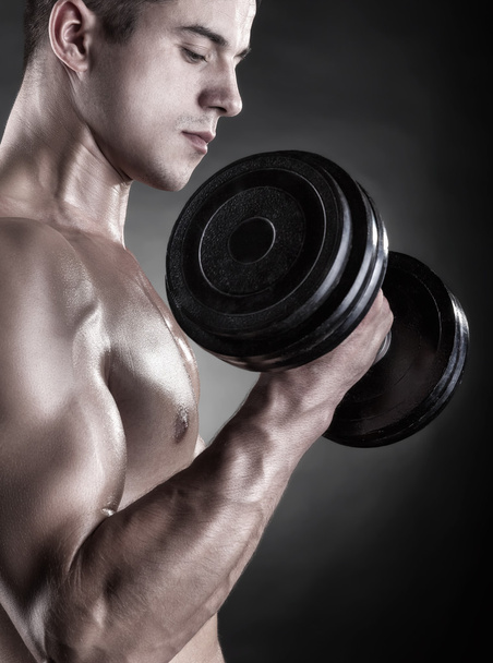Muscular man with dumbbells  - Photo, Image