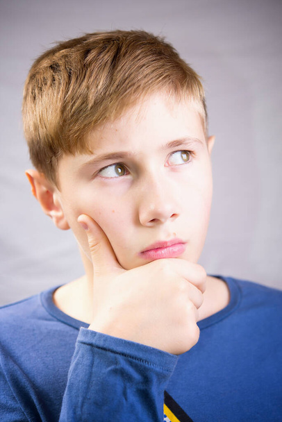 Emotional portrait of a 10-12 years boy. Emotional Portrait of thinking. - Fotó, kép