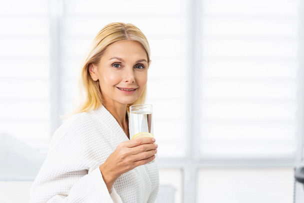 Happy female patient with a healthy drink - 写真・画像