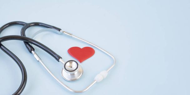 Stethoscope and red heart on a blue background. Greeting background. National doctor's day. Happy nurse 's day. Health day. Top view, a copy of the space. - Foto, Bild