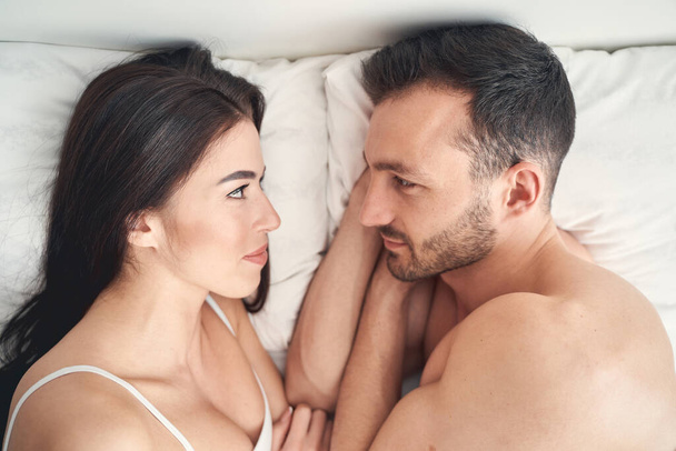 Married romantic young couple lying in bed - Fotó, kép