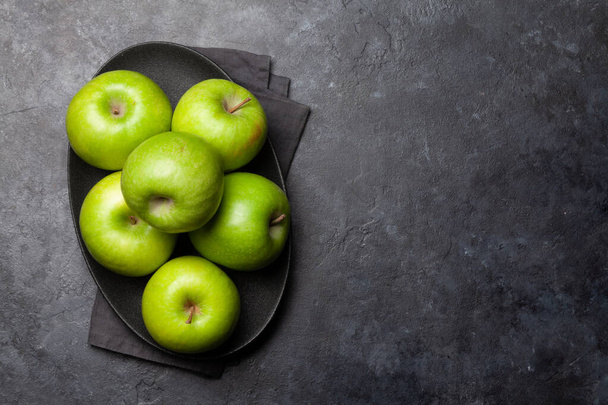 Ripe green apple fruits on dark stone table. Top view with copy space. Flat lay - Photo, Image