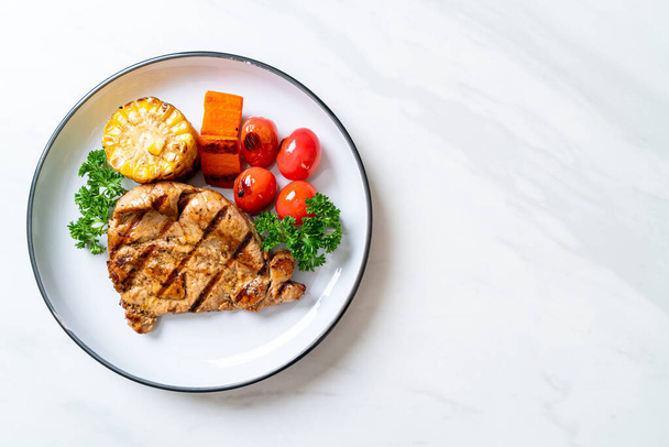 grilled and barbecue fillet pork steak with corn, carrot and tomatoes - Photo, Image