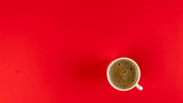 Glass of hot coffee on a red background. place for text. Mock up - Foto, Imagen