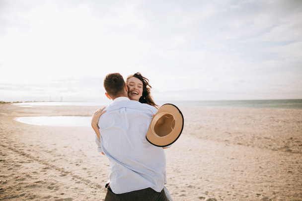 Couple in love hugging at sea. Honeymoon and vacation at sea - 写真・画像