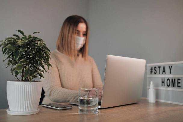Portrait of One Beautiful Girl in White Medical Mask Working from Home - Photo, Image