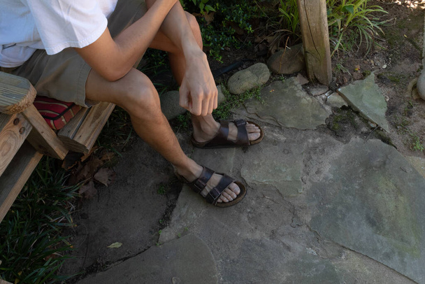 Ноги и руки молодого человека на каменном фоне, творческое пространство для копирования, горизонтальный аспект
 - Фото, изображение