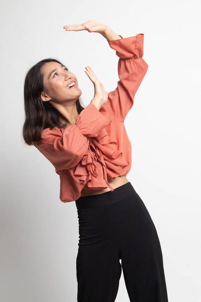 Excited young Asian woman look up on white background - 写真・画像