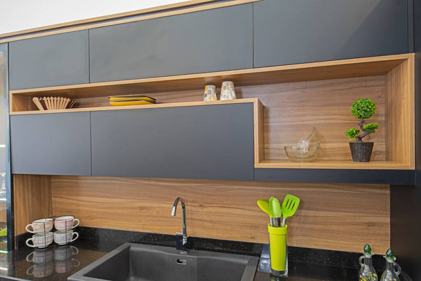 Interior design decor showing modern kitchen with cupboards in luxury apartment showroom - Foto, afbeelding