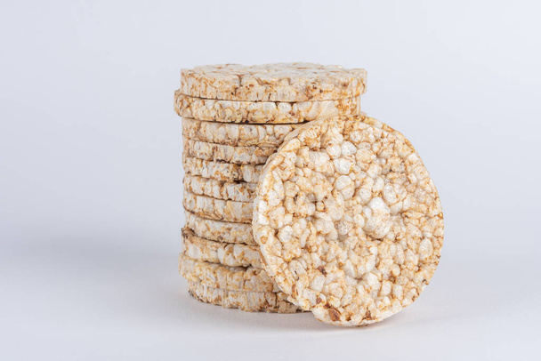 Stack of crunchy rice cakes on white table. Food background. - Foto, Imagen