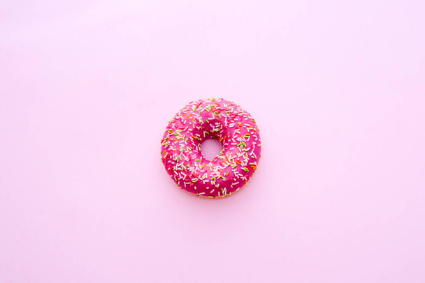One Pink donut on a pink background - Foto, Imagen