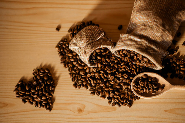 Coffee crop in sack Coffee heap with great texture and ambiance - Photo, Image