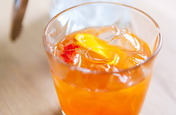 Whiskey orange cocktail with ice cubes.Refreshing alcoholic drink in glass.Delicious strong alcohol cocktails with fruit slice and bourbon whisky - 写真・画像