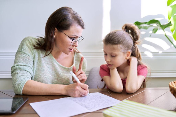 Mother and daughter child study together at home - Foto, Imagen