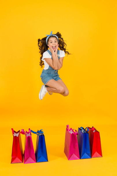 happy little beauty jump high. little shopper choose purchase. gift for any taste. sell-out concept. summer fashion shopping. savings on purchases. big deal discount. small girl has retro look - Photo, Image