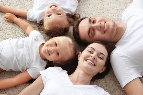 Happy parents with children lying on floor - Valokuva, kuva