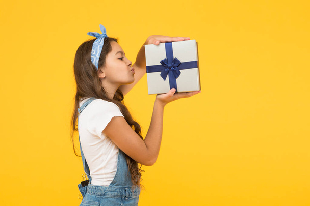 Excitement. happy birthday gift. childhood happiness. concept of boxing day. shopping for kids. reward and prize. flash sale. summer retro child. girl kiss received present box. surprise for her - Photo, Image