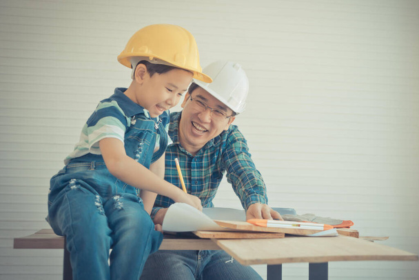 Father is teaching his son to fo the DIY home improvement work for parent and family bonding concept. - Фото, зображення