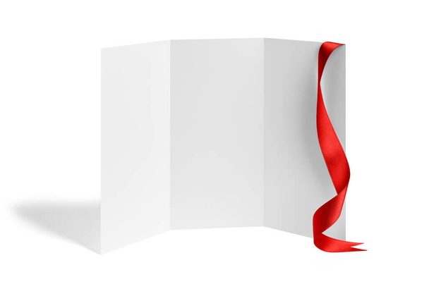 close up of a note card or leaflet brochure with ribbon bow on white background - Photo, Image