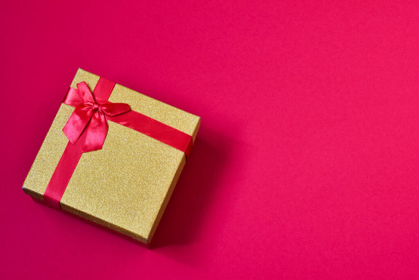Bright holiday box - a gift on a red background. Holiday concept. - Фото, зображення