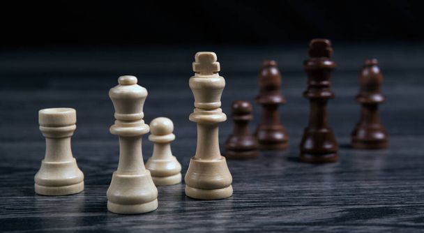 various chess pieces on a wooden background - 写真・画像