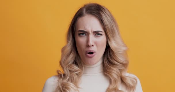 Shocked blonde woman looking at camera, feeling amazement - Footage, Video