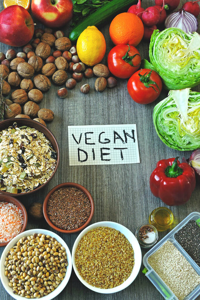 A set of products for a vegan diet. Fruits, vegetables, seeds, cereals, nuts. A note with an inscription vegan diet. Flat Lay. - Photo, Image