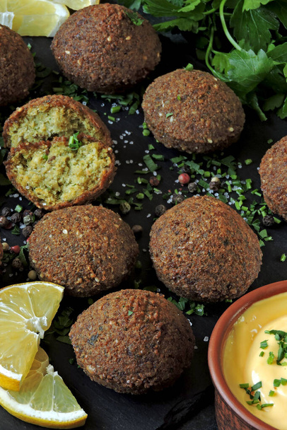 Verse falafelballen, pita, saus en kruiden. Veganistische falafel. Midden-Oosten keuken. - Foto, afbeelding