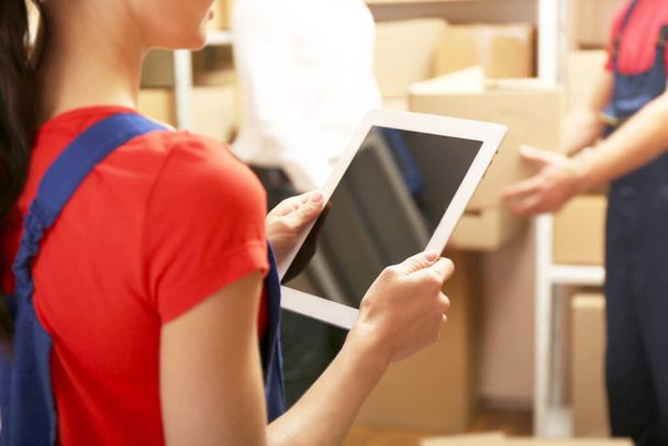 Young businesswoman with tablet at warehouse - Foto, imagen