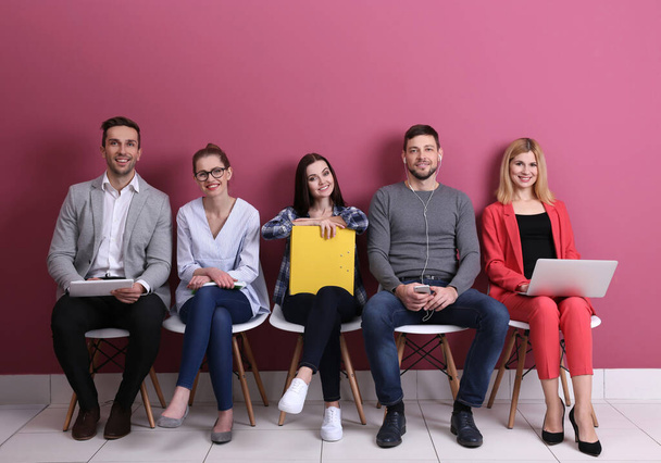 Group of people waiting for job interview on colour background - Photo, Image