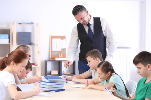 Male teacher conducting lesson in classroom - Photo, Image