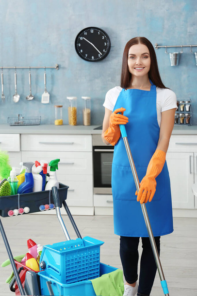 Beautiful woman with cleaning tools at home - Фото, зображення