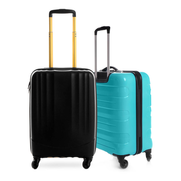 Stylish suitcases for travelling on white background - Foto, imagen