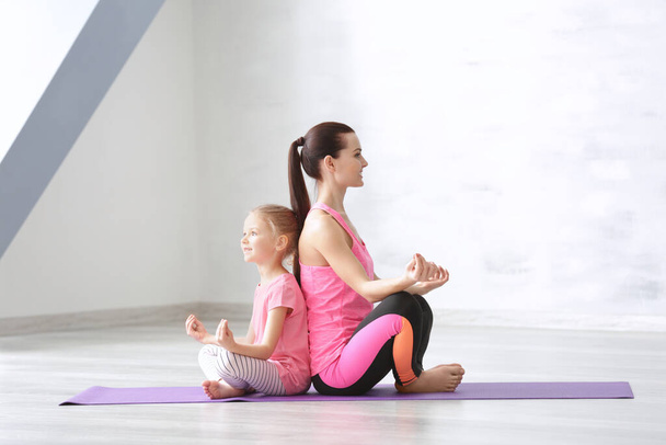 Mother and daughter doing exercise indoors - Photo, Image