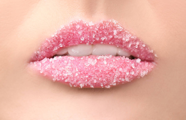 Lips of beautiful young woman covered with sugar, closeup - Foto, afbeelding