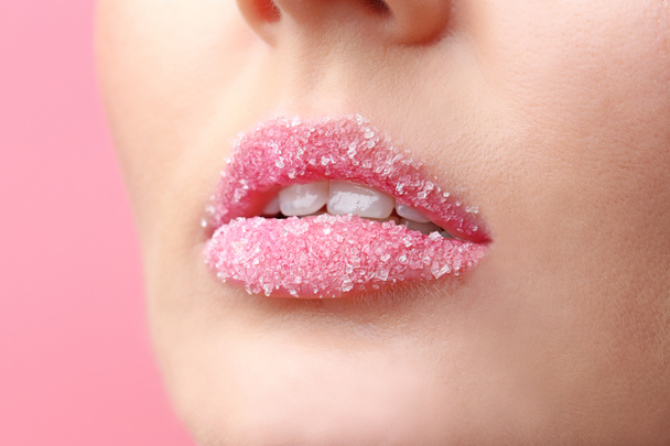 Lips of beautiful young woman covered with sugar, closeup - Foto, afbeelding