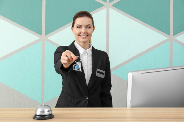 Female receptionist with room key in hotel - 写真・画像