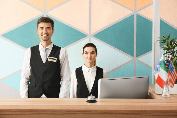 Female and male receptionists working in hotel - Foto, imagen