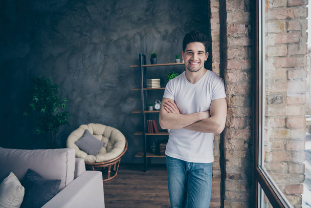 Portrait of his he nice attractive cheerful cheery content guy father dad day daydream comfort life folded arms at modern industrial loft concrete brick interior style living-room indoors - Фото, зображення