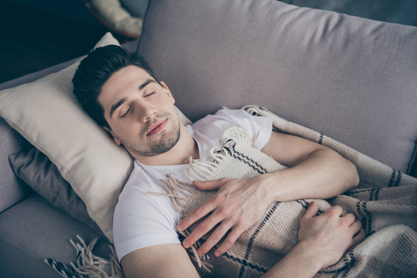 Close-up portrait of his he nice attractive calm peaceful tranquil sleepy virile brunette guy lying on divan resting sleeping in living-room indoors - Photo, Image